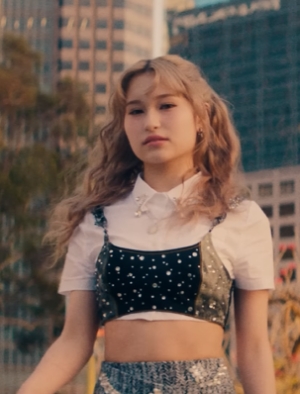 Emi walking down the street in their debut music video