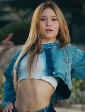 A screenshot of Michelle dancing in their debut music video